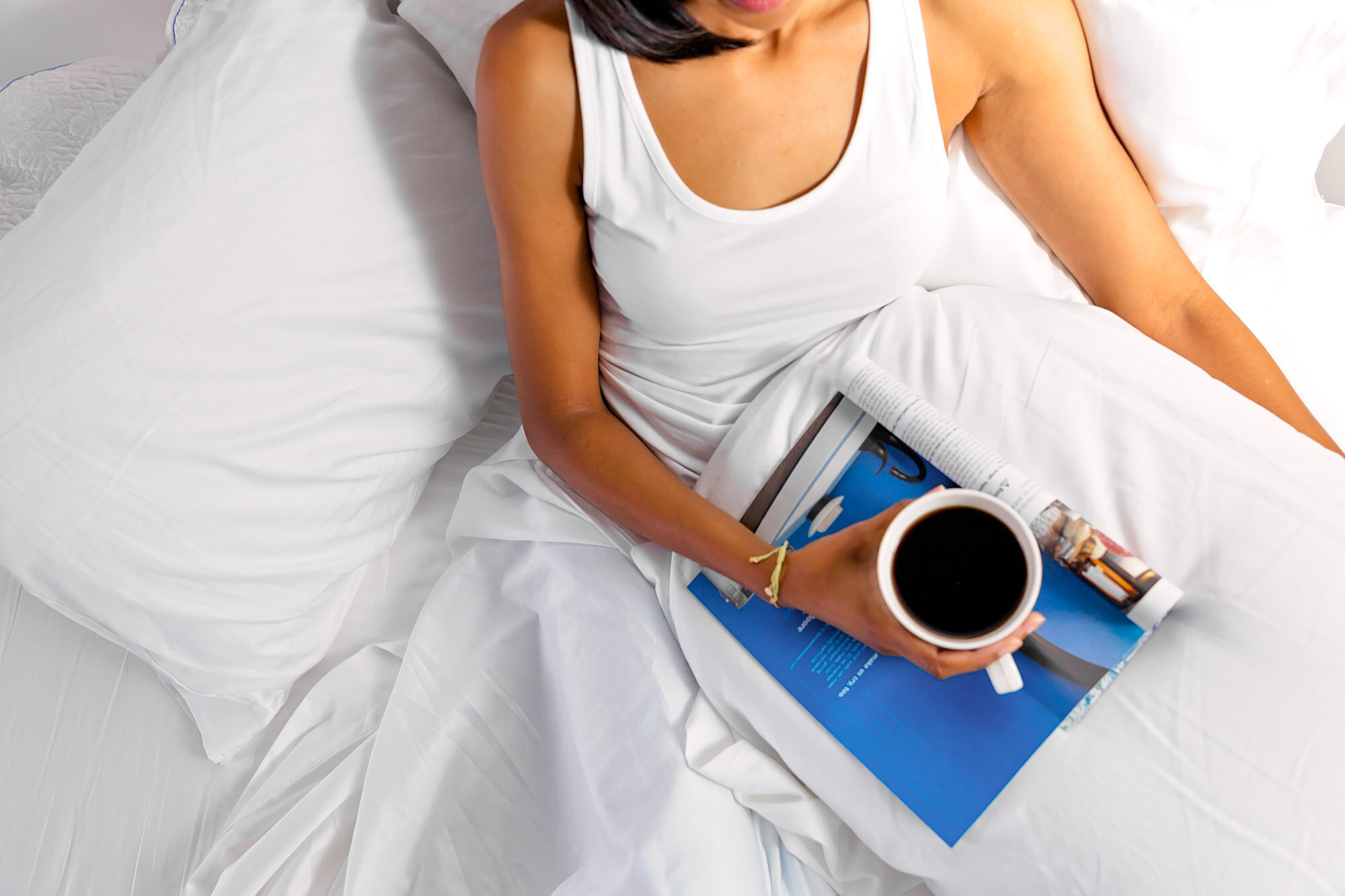 Photo of woman in bed holding a coffee mug